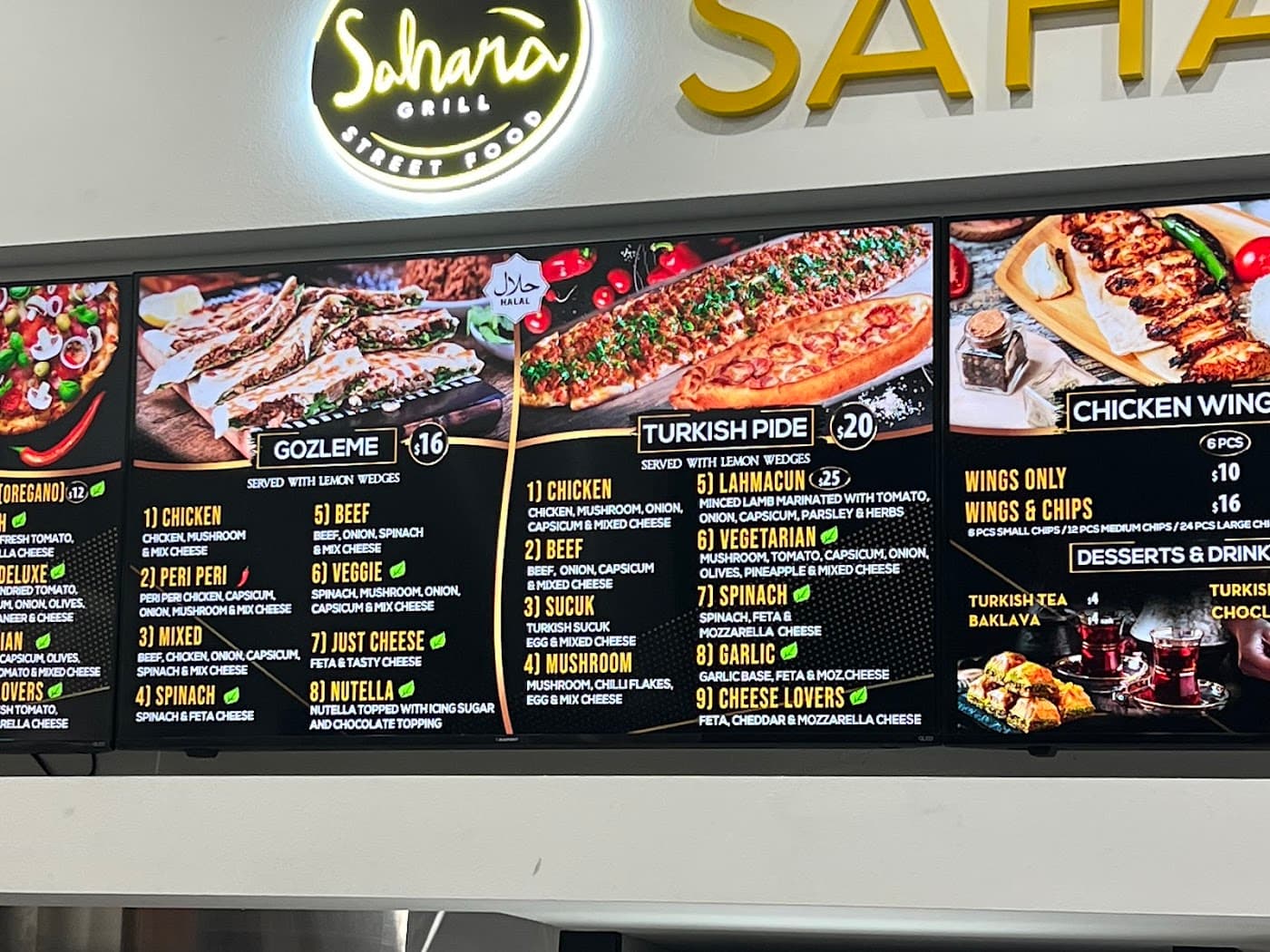 A variety of Sahara Grill's flame-grilled meats, including lamb shish and adana kebabs, served on a traditional platter.