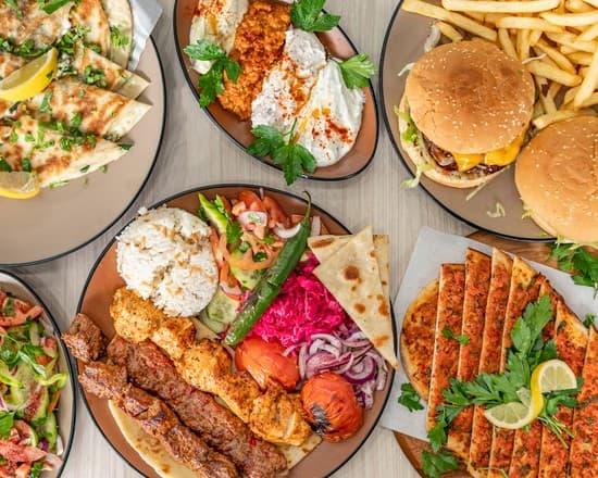 Close-up of Sahara Grill's signature marinated beef and chicken kebabs being carved fresh from the spit.