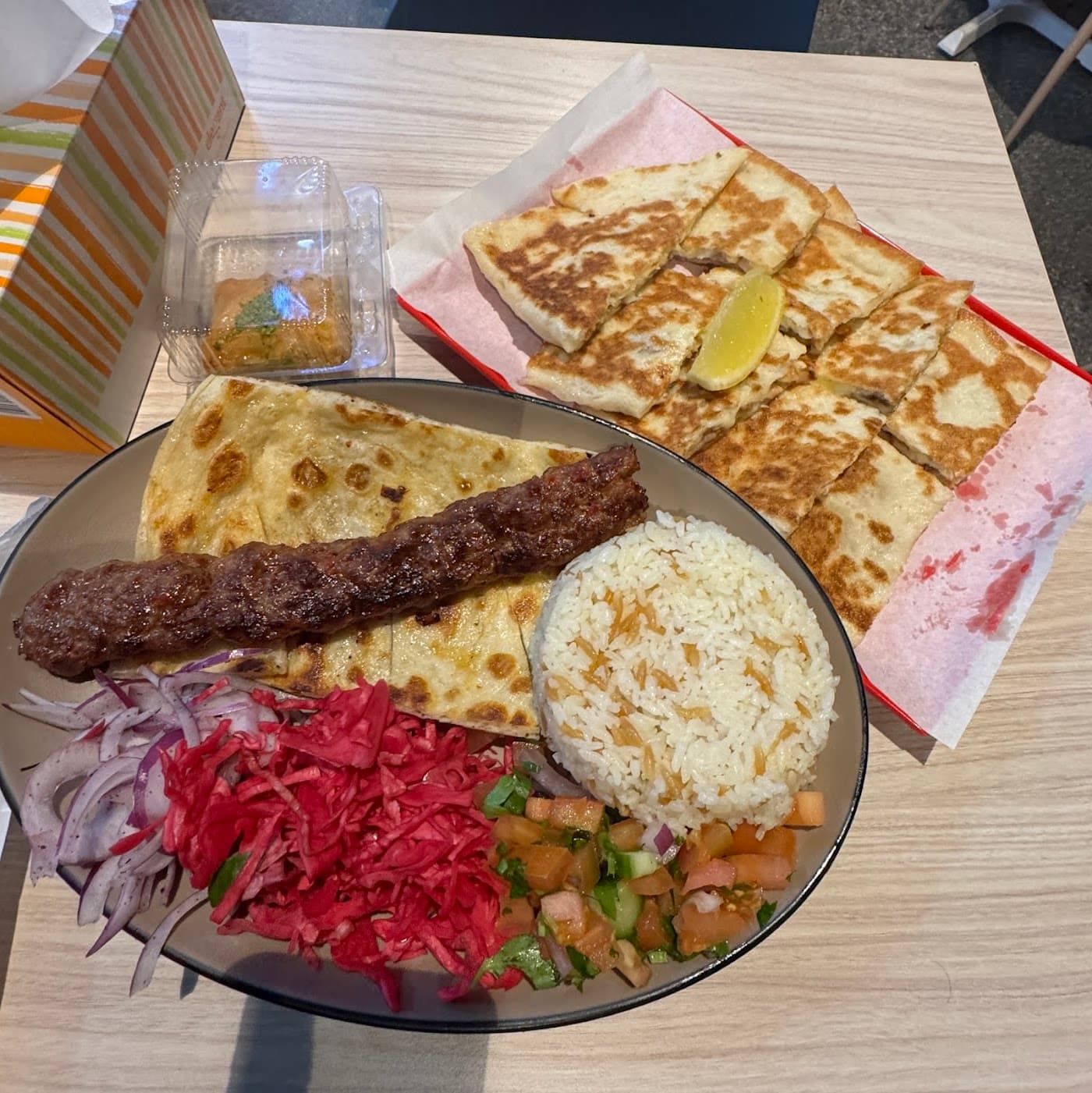 The inviting black-and-gold themed interior of Sahara Grill, where fresh Turkish salads and sides are prepared daily.